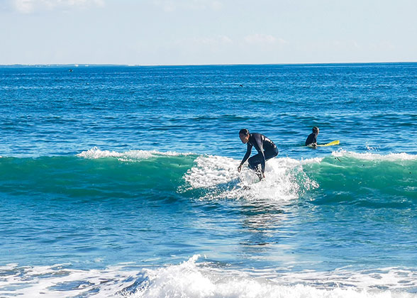 People Surfing on the Sea