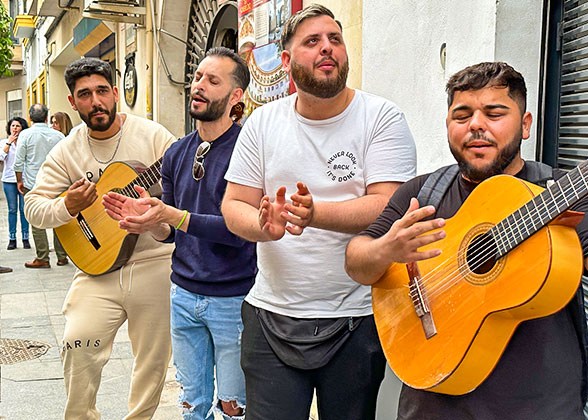 Locals Enjoy a Happy Moment by Playing the Guitar
