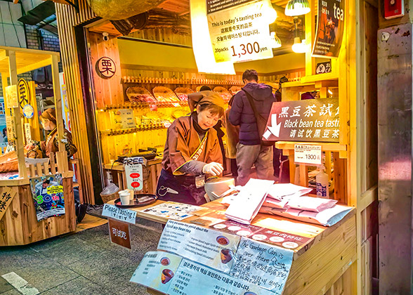An old lady is making traditional nara food before the shop