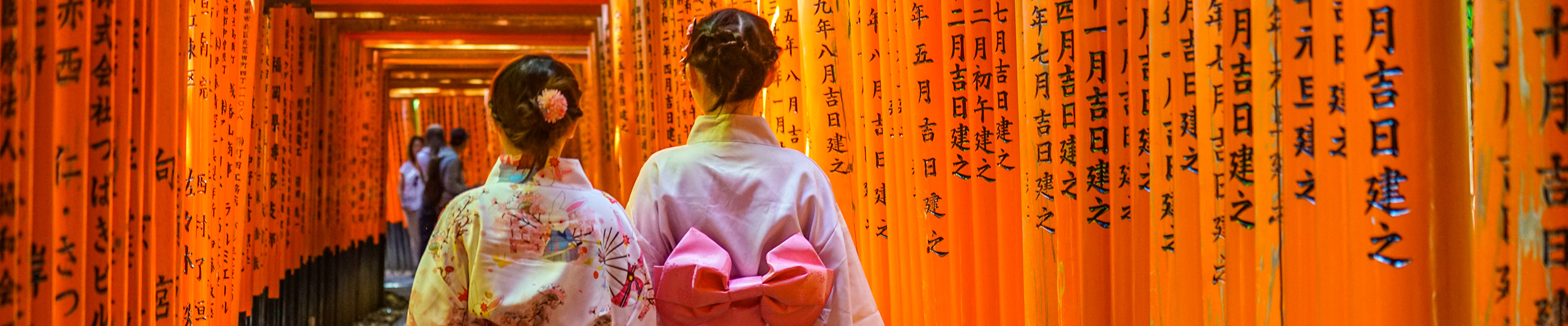 Girls in Kimono under the torii gates