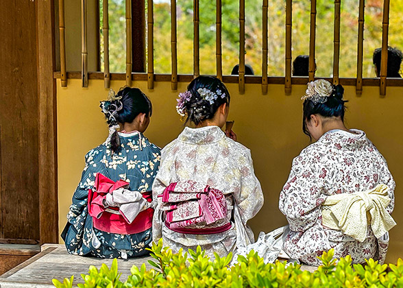 Girls in Kimono sitting in the Shrine