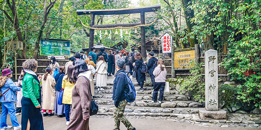 Visitors standing before Nonomiya Shrine
