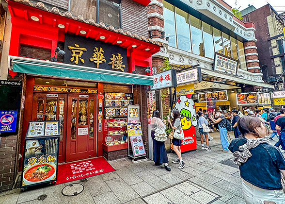 Visitors standing by a Chinese cuisine restaurant