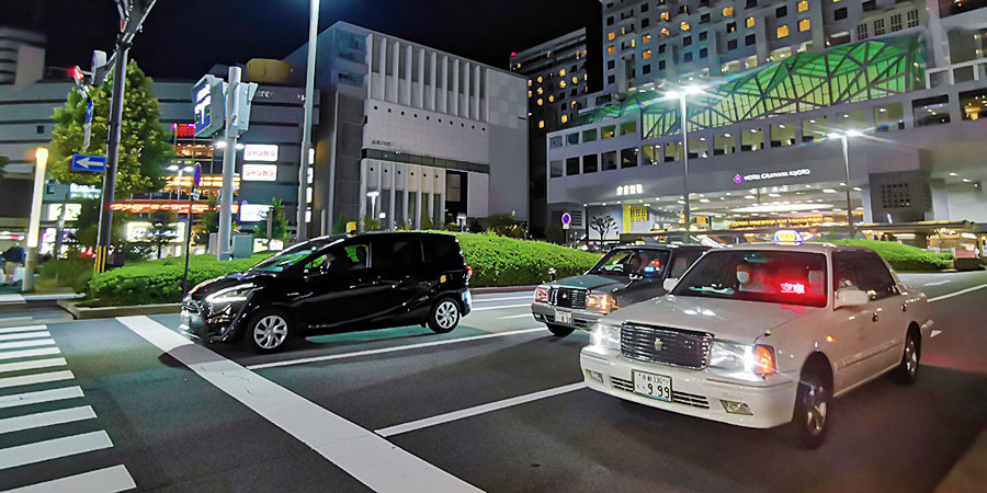 The Taxi with Top Light and Red Lettering On is Available for Taking