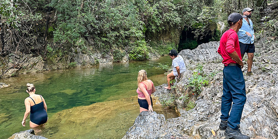 Visitors Swimming in Pool of Anjohibe Caves