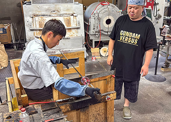 Visitors experiencing glassmaking
